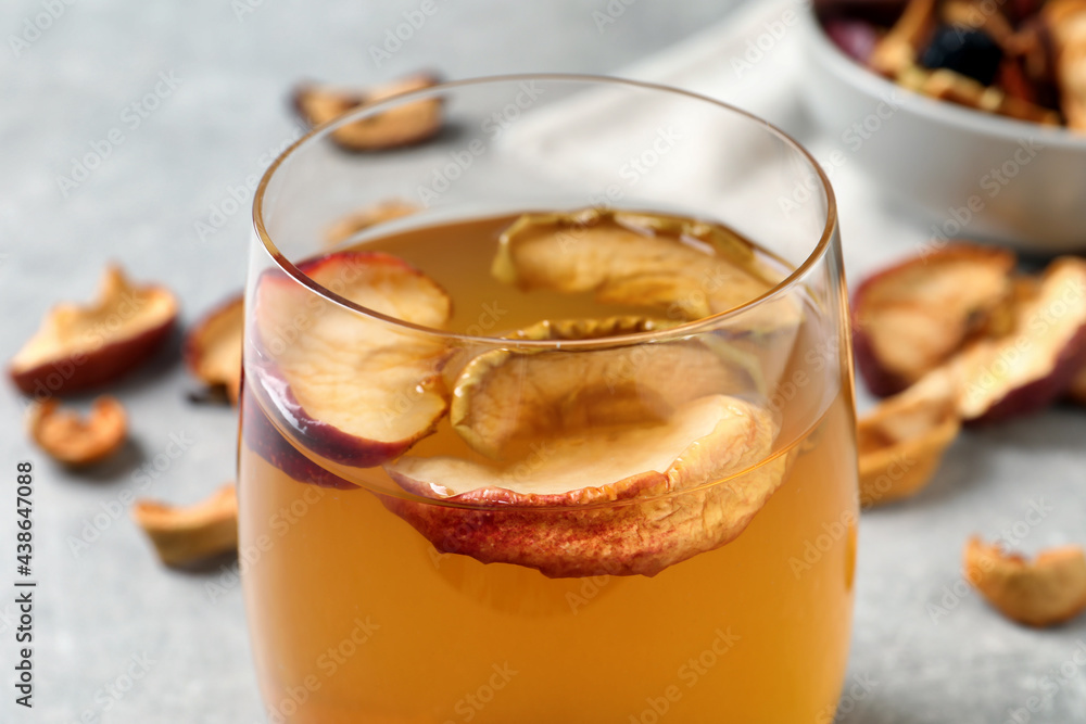 Delicious compote with dried apple slices in glass on table, closeup Delicious compote with dried apple slices in glass on table, closeup