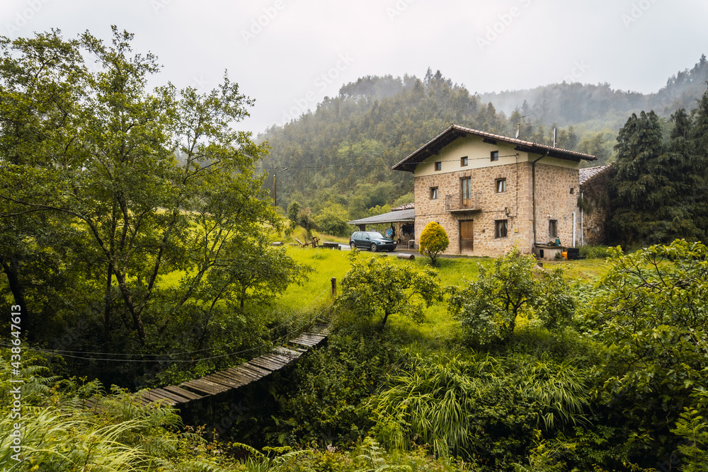 A beautiful farmhouse in the rain forest. Spring on the road from Ispaster to Lekeitio, landscapes of Bizkaia. Basque Country