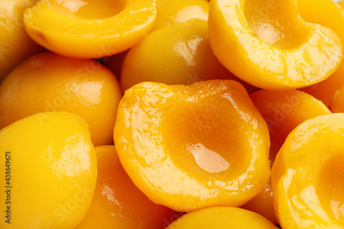 Halves of canned peaches as background, closeup