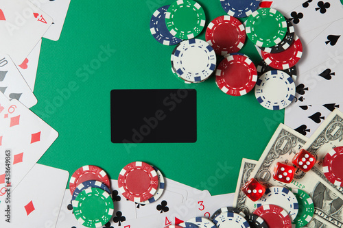 Classic playing cards, chips, red dice and dollars on green background. Gambling and casino concept.