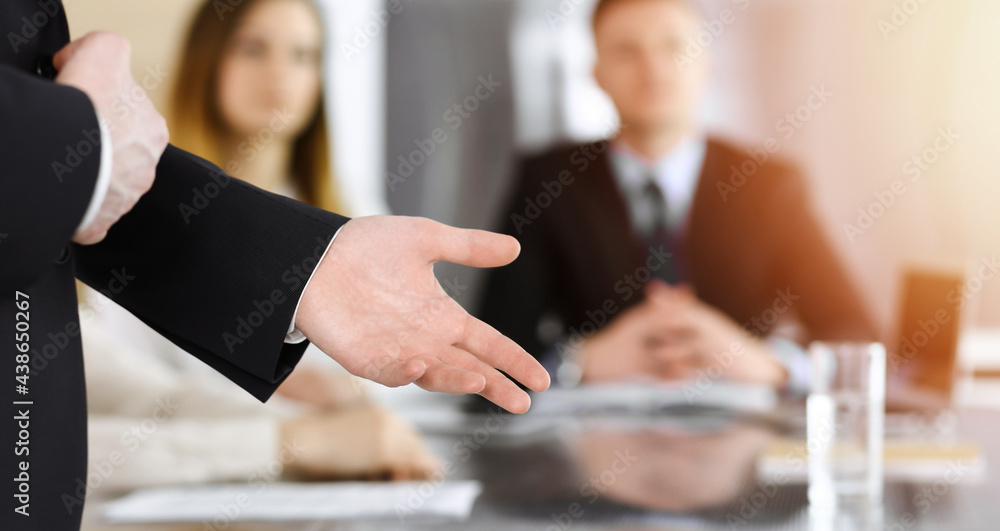 Business presentation. Businessman giving speech to colleagues and partners at corporate meeting or conference, close-up of speaker hands Business presentation. Businessman giving speech to colleagues and partners at corporate meeting or conference, close-up of speaker hands