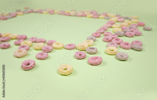 Colorful cereal on a green background