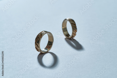 Pair of stylish gilded rings with carvings