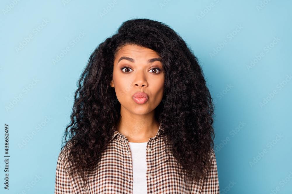 Photo of cool wavy hairdo young lady blow kiss wear brown shirt isolated on vivid blue color background Photo of cool wavy hairdo young lady blow kiss wear brown shirt isolated on vivid blue color background