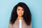 Photo of sad wavy hairdo young lady bite lip wear brown shirt isolated on vivid blue color background