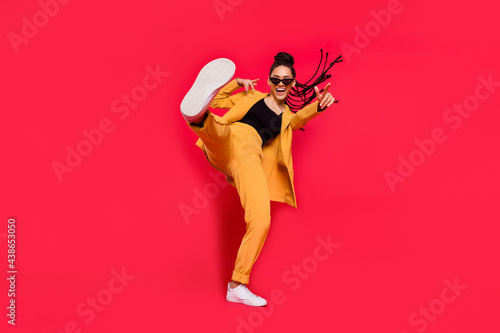 Fototapeta Naklejka Na Ścianę i Meble -  Full body photo of cool lady dance wear eyewear yellow suit isolated on vivid red color background