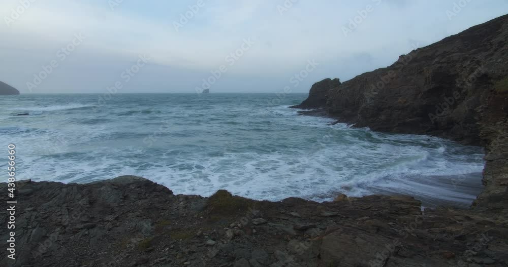 Ocean Waves And Sea Cliffs At Trevellas Cove In St Agnes, Cornwall, UK - panning shot Ocean Waves And Sea Cliffs At Trevellas Cove In St Agnes, Cornwall, UK - panning shot