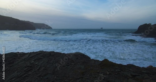 Rolling White Foamy Waves On The Sea Surface At Trevellas Cove In St Agnes, Cornwall, UK - wide shot photo