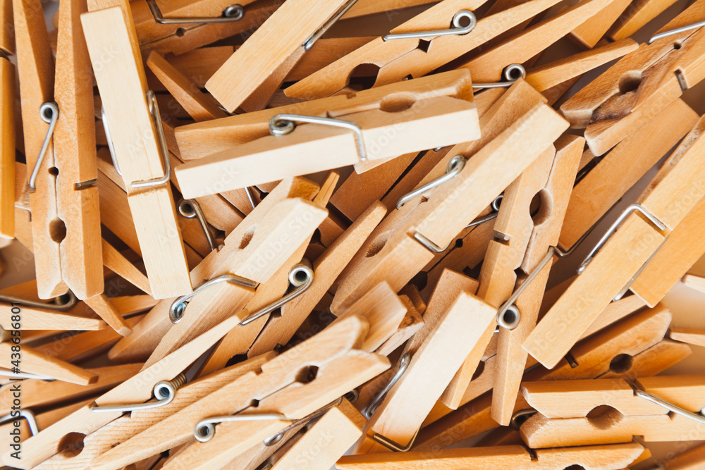 Many wooden clothespins piled up