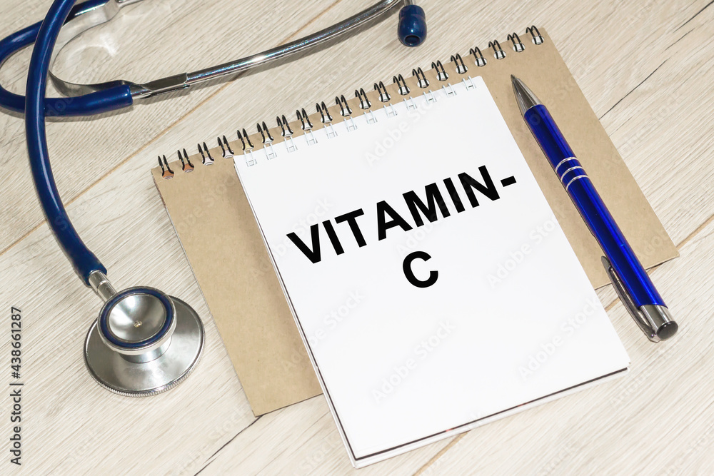 VITAMIN C. Medicine and health concept. On a table lies a stethoscope, WITH notebook. VITAMIN C. Medicine and health concept. On a table lies a stethoscope, WITH notebook.