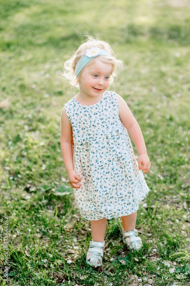 Little girl playing on the grass Little girl playing on the grass