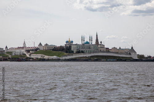 Beautiful towers, a fortress and a mosque on the banks of the river. Kazan Kremlin. City landscape near the river. Ancient architecture.