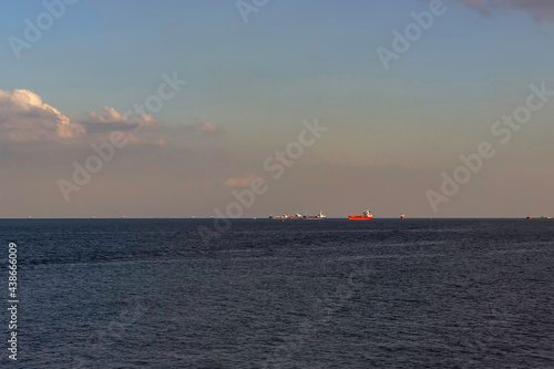 Ships are drifting in the sea in the distance