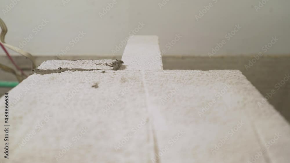 Building a wall from blocks. A worker builds a wall from blocks. Mason making a wall from concrete blocks. Interior walls from a block in a new apartment. Building a wall from blocks. A worker builds a wall from blocks. Mason making a wall from concrete blocks. Interior walls from a block in a new apartment.