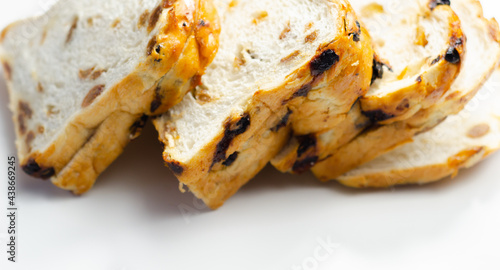 Fruit loaf with sultanas and orange flavored pieces on the white background