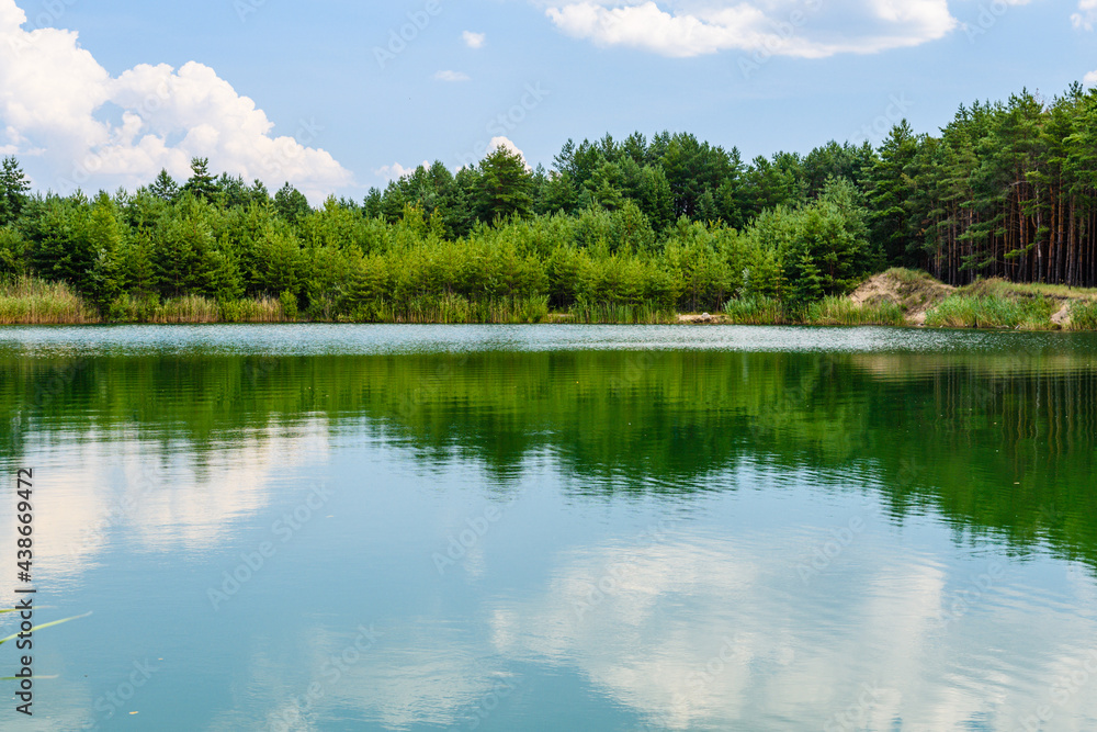 View on a lake in the abandoned sand quarry and dramatic sky View on a lake in the abandoned sand quarry and dramatic sky