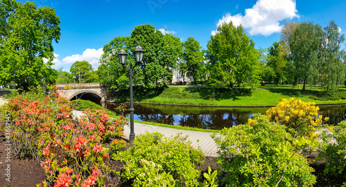 Panorama of the Riga canal against the background of blooming rhododendrons in beautiful Kronvalda Park, Riga, Latvia.