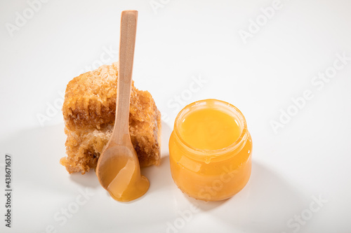 fresh honey in honeycombs on a white background