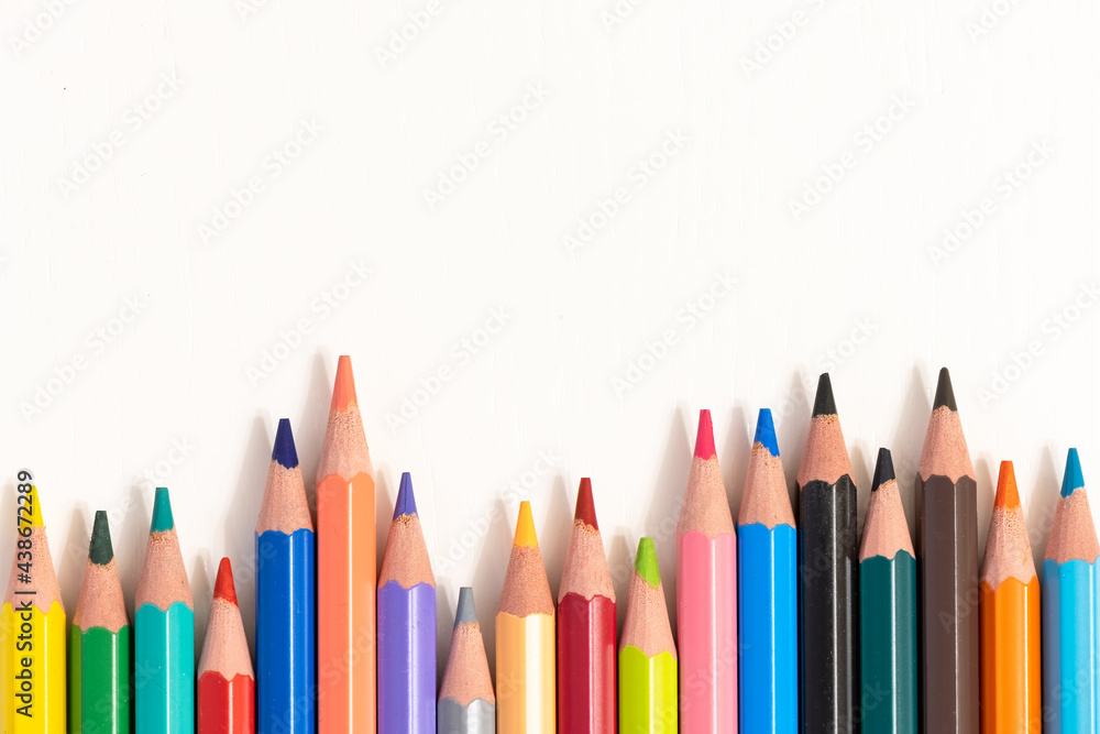 Color pencils on white background, top view with space for text. Back to school concept copy space for text Color pencils on white background, top view with space for text. Back to school concept copy space for text