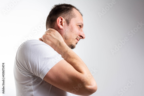 Handsome Male suffering from pain in neck. Symptom of cervical chondrosis. Inflammation of vertebra, side view. Man suffer for stiff neck.