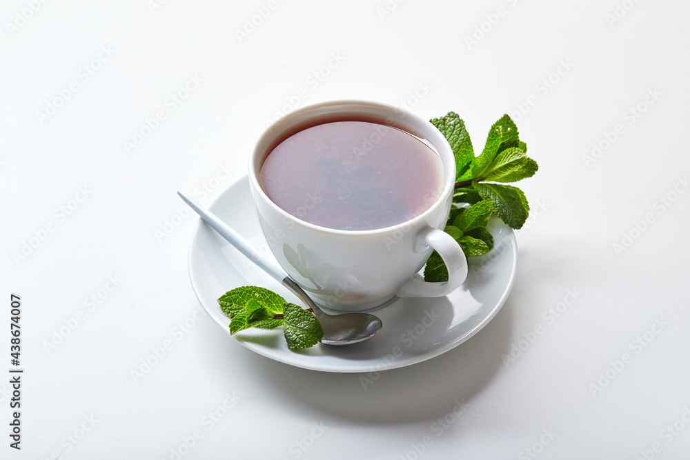 Black tea in white cup with mint leaves. Soothing tea, anti-stress Black tea in white cup with mint leaves. Soothing tea, anti-stress