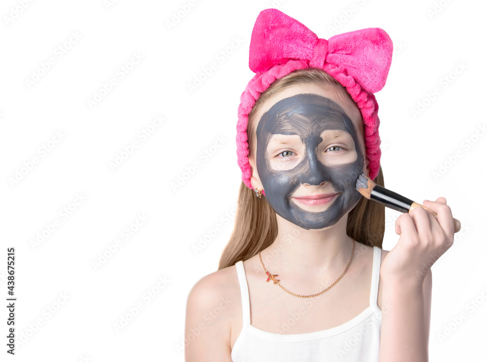 Girl with a cleansing mask on her face. Home skin care. Girl with a cleansing mask on her face. Home skin care.