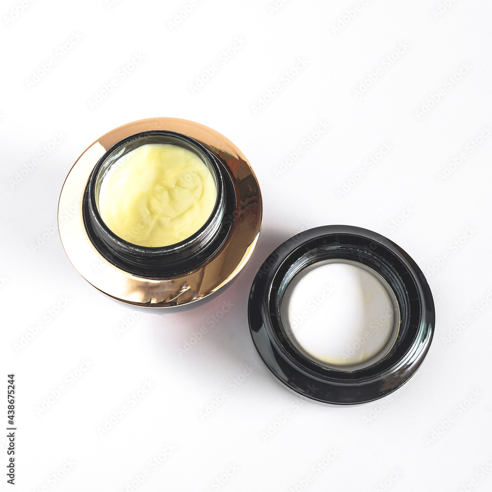 Cosmetic jar and treatment cream or lotion on background. Cosmetic jar and treatment cream or lotion on background.