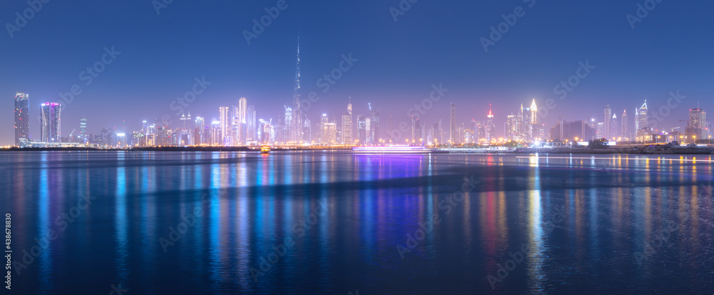 Panoramic view of the Burj Khalifa and other skyscrapers in the financial center of Dubai in the UAE with reflections in the waters of the Creek Channel