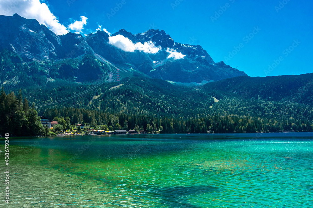 Faboulus landscape of Eibsee Lake with turquoise water in front of Zugspitze summit under sunlight. Location: Eibsee lake, Garmisch-Partenkirchen Bavarian alps, Germany, Europe