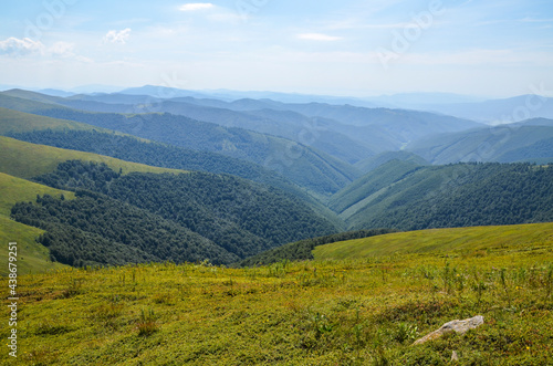 Beautiful mountain panorama with green mountains and layers of hills with forest. Beautiful summer colors in Carpathians, Ukraine