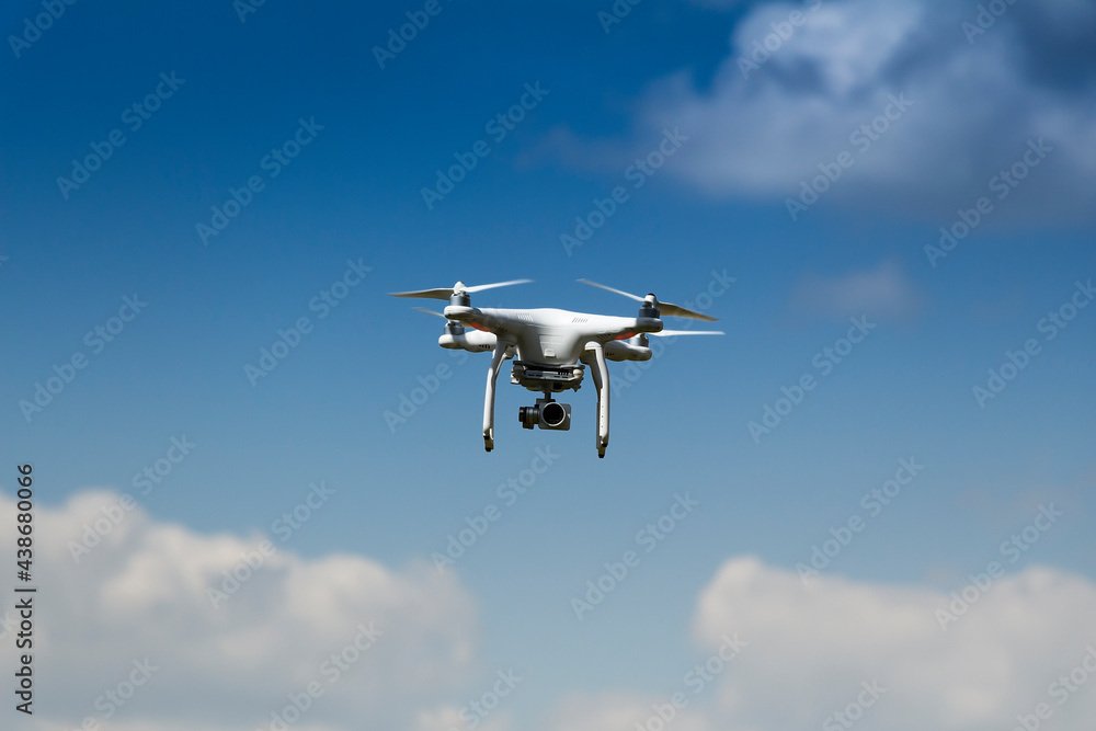 drone on a background of blue sky with clouds. quadcopter in flight. sunny day. drone on a background of blue sky with clouds. quadcopter in flight. sunny day.