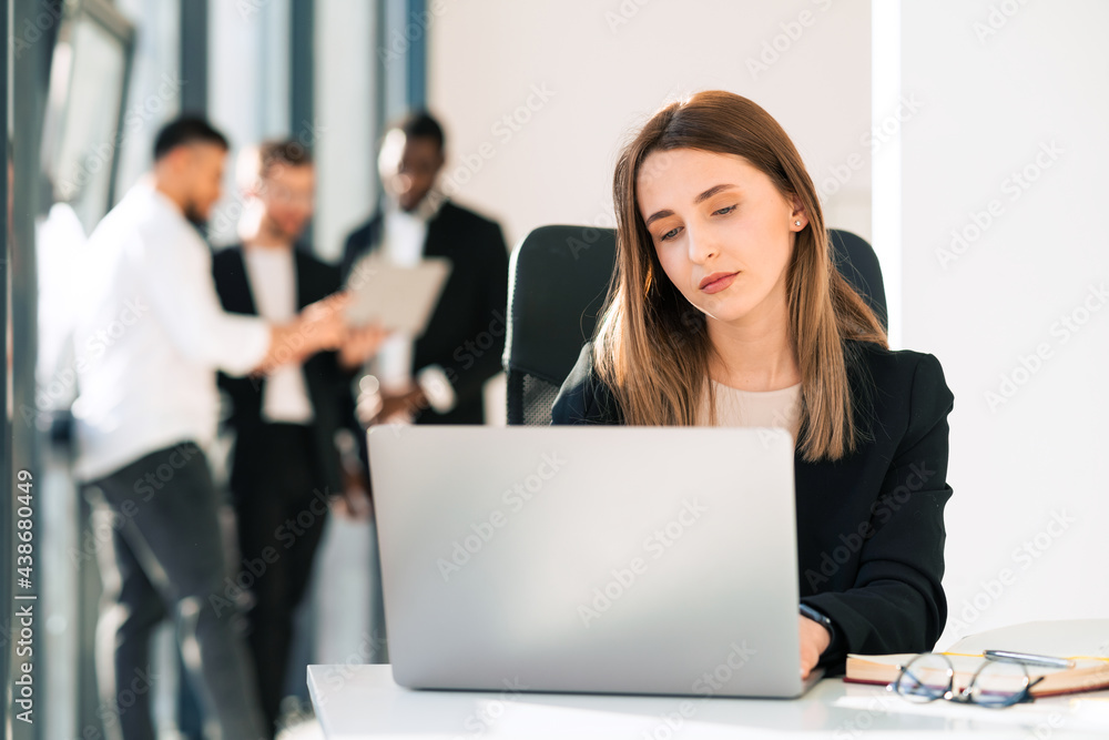 Beautiful office woman working on laptop in the office Beautiful office woman working on laptop in the office