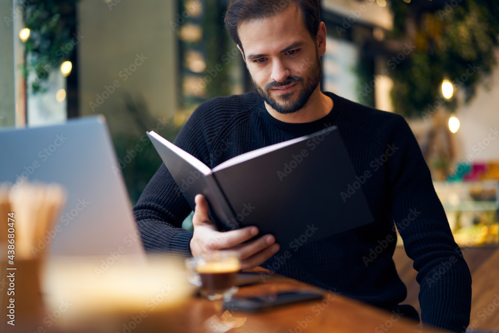 Positive ethnic man reading book Positive ethnic man reading book