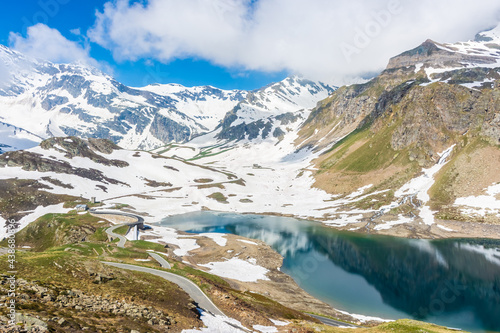 Beautiful emerald Alpine Lake in the snowy landscape in Gran Paradiso National Park Italy