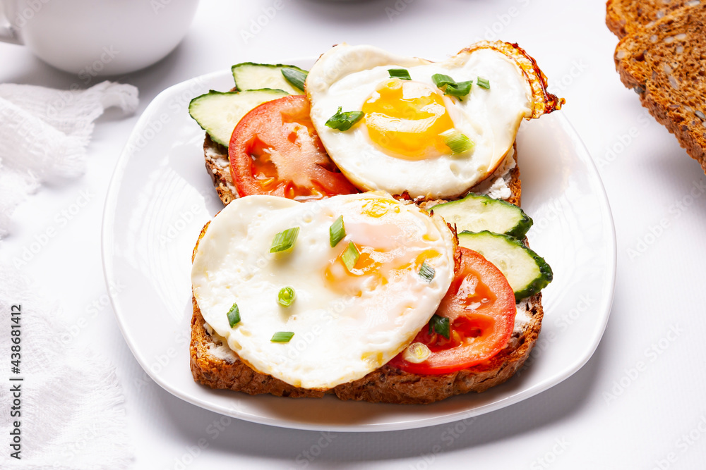 Sandwiches with egg, tomatoes, cucumber on toasted bread. Close up.