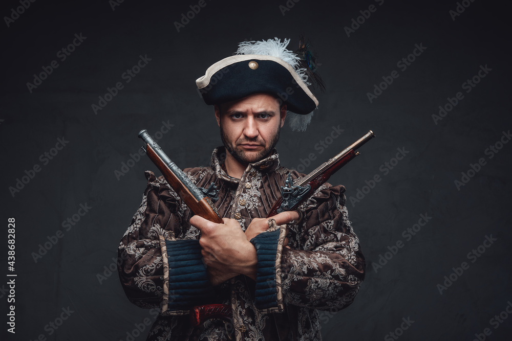 Fototapeta premium Pirate with crossed pistols against dark backgound