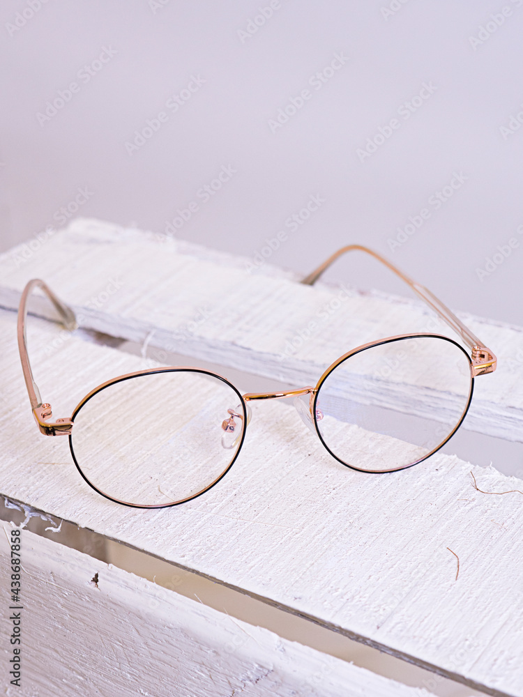 gold glasses on chest with white background gold glasses on chest with white background