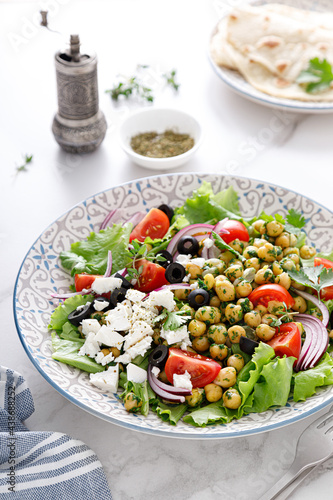 Mediterranean Greek and chickpea salad with fresh vegetables and feta cheese, top view