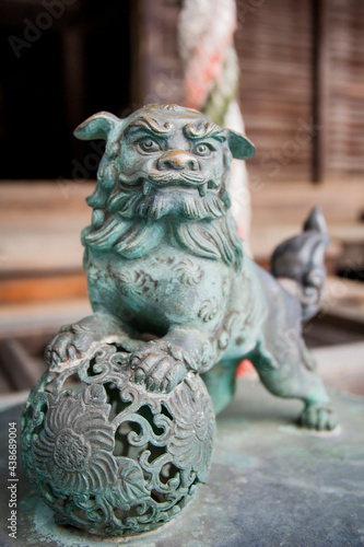 Bronze sculpture of a lion, commonly used in Buddhist temples.