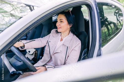 lifestyle and people concept - happy smiling young woman driver driving a car. © Ivan