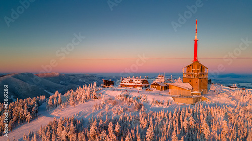Winter sunrise on Lysa Hora mountain. Th highest peak of Beskydy mountains in the east part of Czech Republic. High quality aerial panorama.