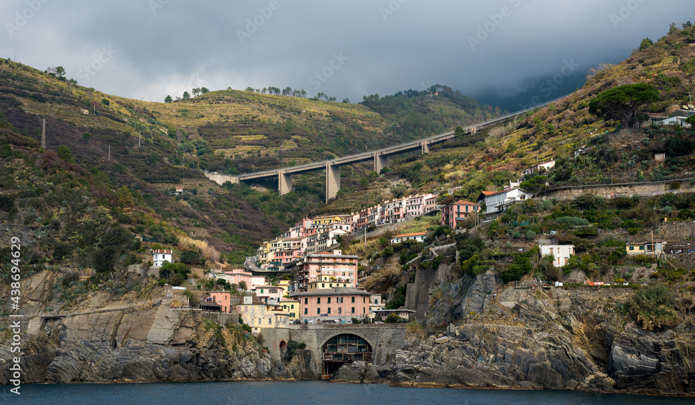 City of Riomaggiore at the edge of a rocky cliff, Cinque Terre Liguria, Italy