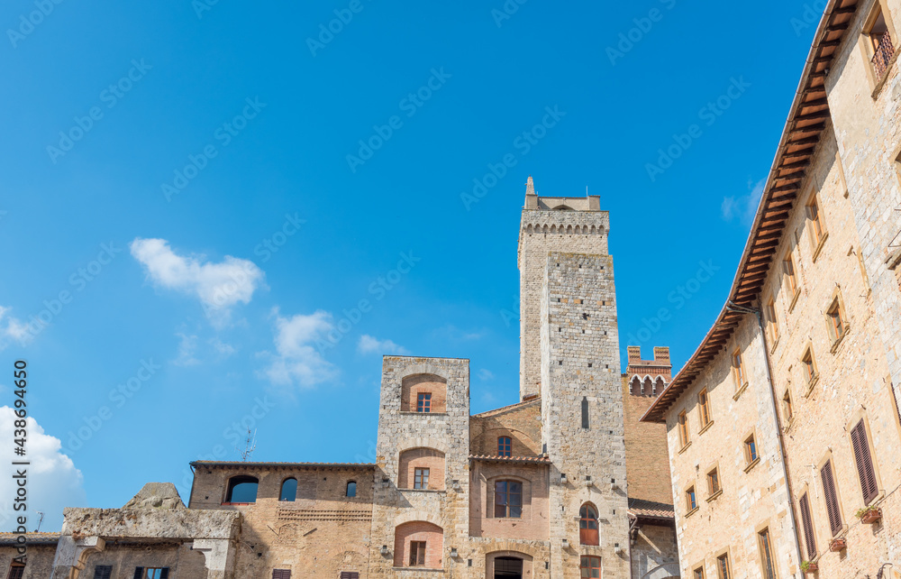 Historical architecture buildings, San Gimignano city Tuscany, Italy against blue sky