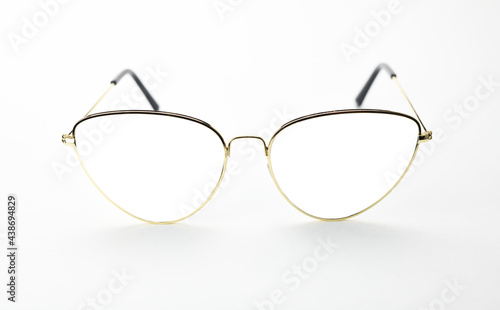 Fashionable sunglasses in thin gold frames with a white background to add images. 