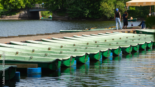 rental rowing boats in the park, rowing boats on the river, wooden pier with boats, swim on the water