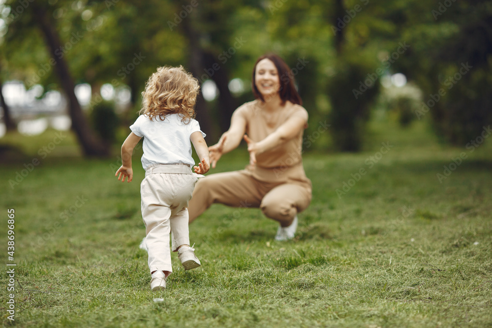 Elegant mother with daughter in a summer forest Elegant mother with daughter in a summer forest