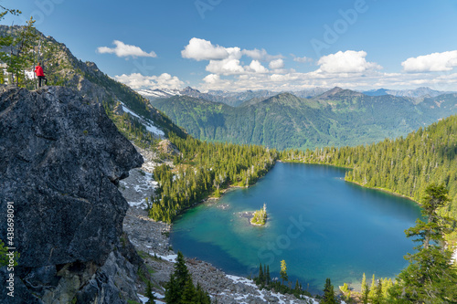 Person Standing over a Cliff overlooking a beautiful landscape in the pacific northwest photo