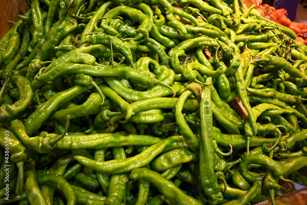 Fresh green long hot peppers ready for picking at local farmers market. Fresh green long hot peppers ready for picking at local farmers market.