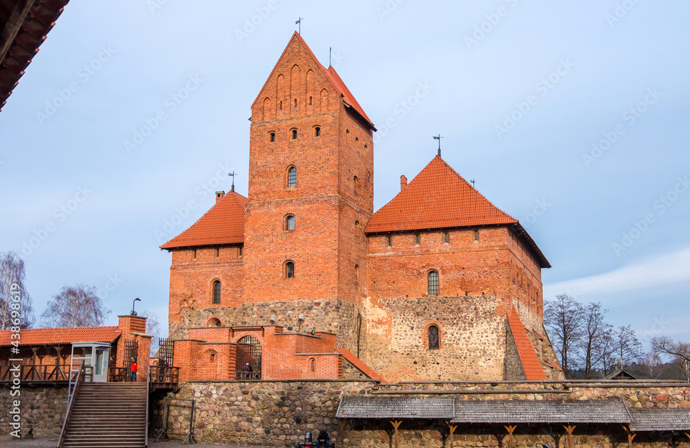 Trakai, Lithuania - February 16, 2020: Medieval gothic Island Castle with stone walls and towers with red tiled roofs. Trakai Castle is one of the most popular tourist destinations in Lithuania