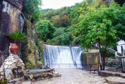 Man-made waterfall in the city of New Athos. Attraction in the city park. The dam. Water falls from a height.